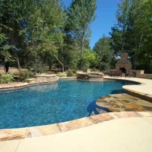 132. Custom pool and spa with stone coping and fireplace