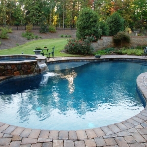 100. Freeform gunite pool with flagstone spa and paver patio