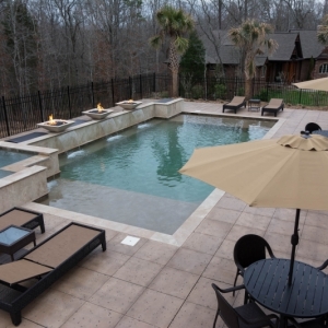 115. Tinted concrete patio. Raised wall pool with firepots
