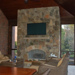 412. Outdoor fireplace in covered patio with television cut out